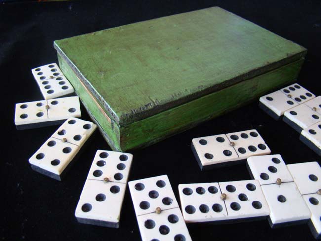 A cased set of 19th century bone and ebony dominoes